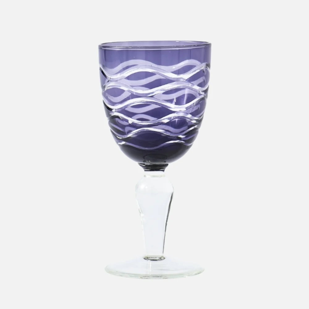 Purple glass goblet with a wavy clear swirl pattern and a clear stem.
