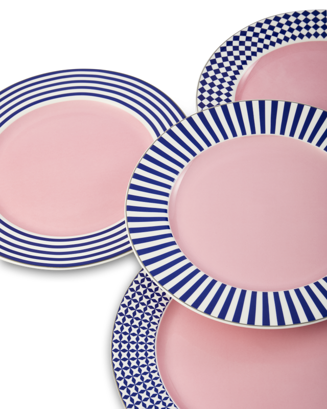 Cluster of pink ceramic plates with blue striped rims overlapping against a black background.