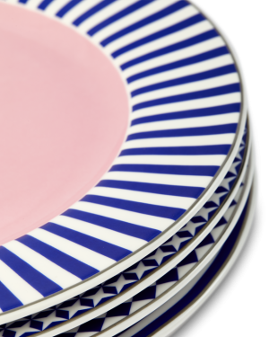 Stack of decorative ceramic plates with blue and white stripes and pink center.